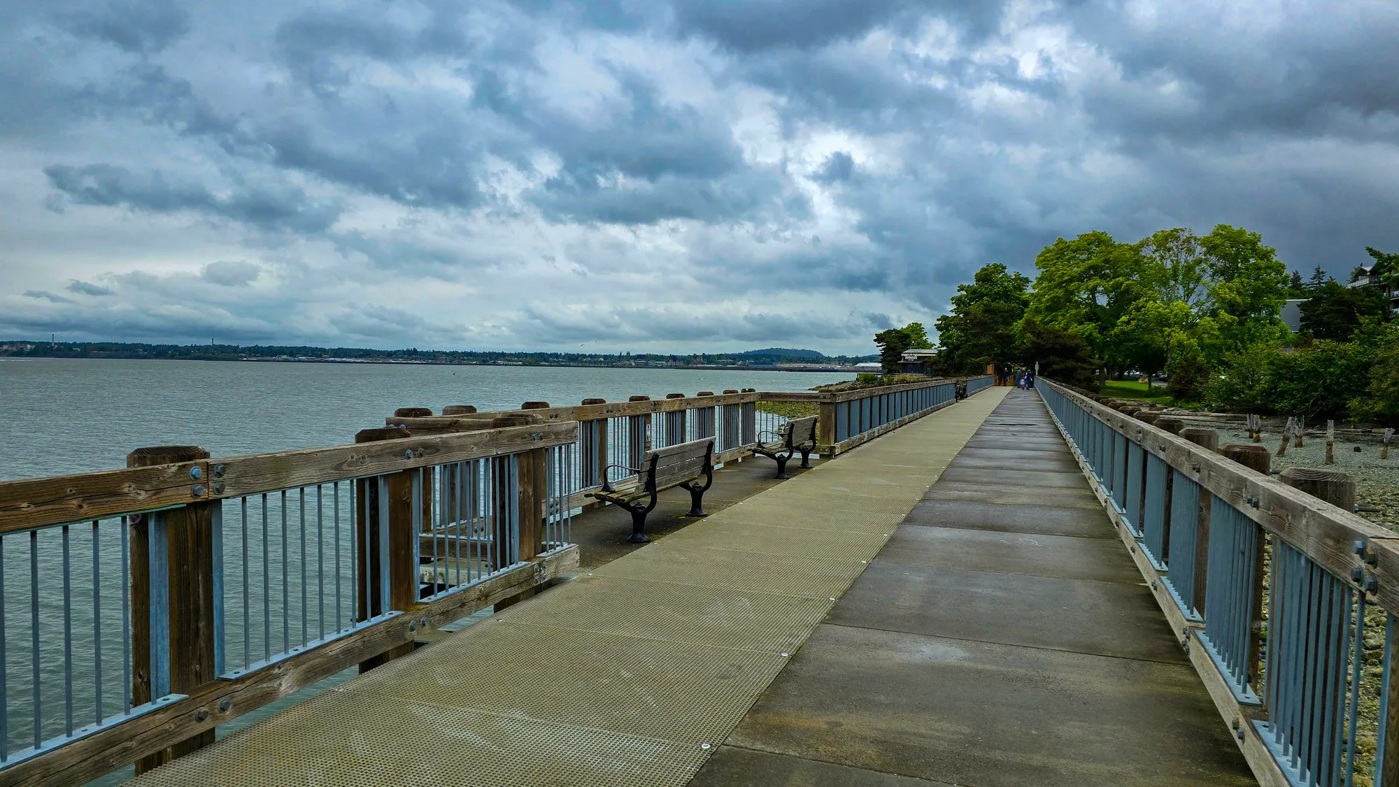 The boardwalk at Boulevard Park in Bellingham over Bellingham Bay under heavy cloud