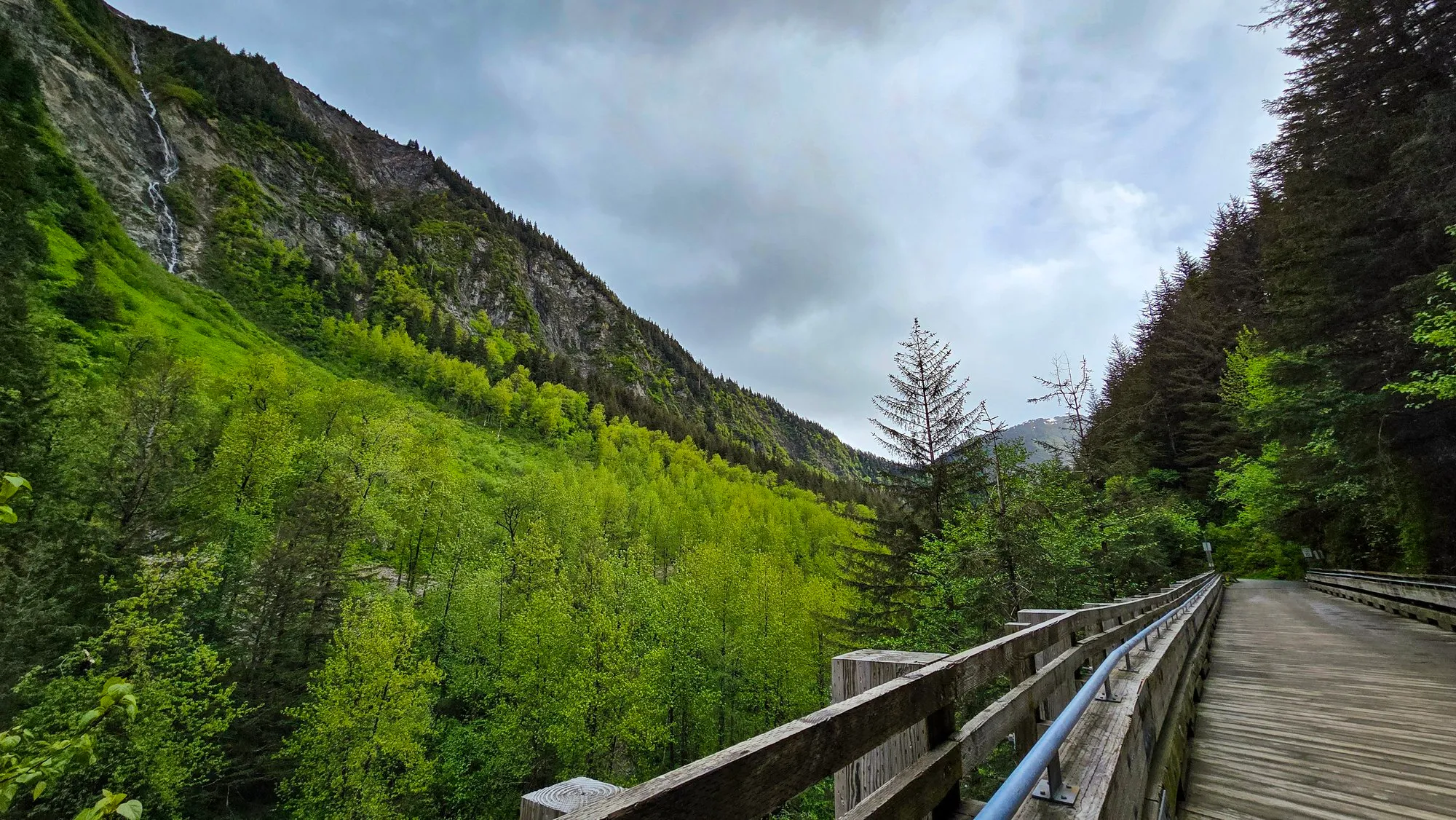 The wooden trestle on Basin Road over Gold Creek, green valley walls on both sides