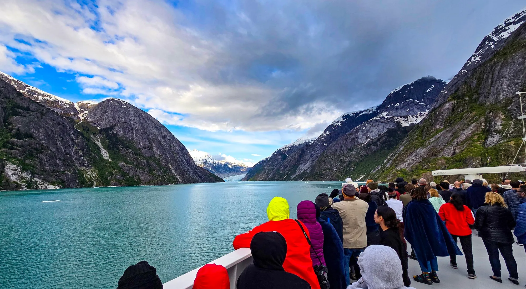 Passengers packed on the bow as the ship enters Endicott Arm