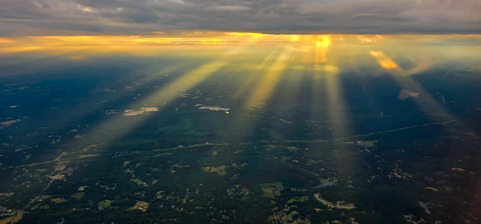 Sun rays through cloud over Georgia from the plane window on the way home