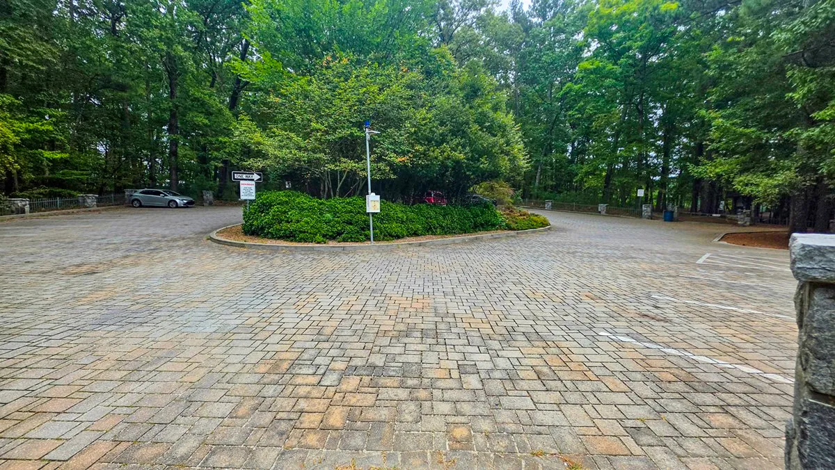The paved lot on Indian Island around its planted center island, trees on every side