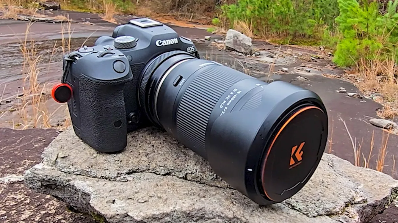 The Tamron 18-400mm on the Canon EOS R7, standing on the granite at Stone Mountain with pines and the wet apron of the rock behind