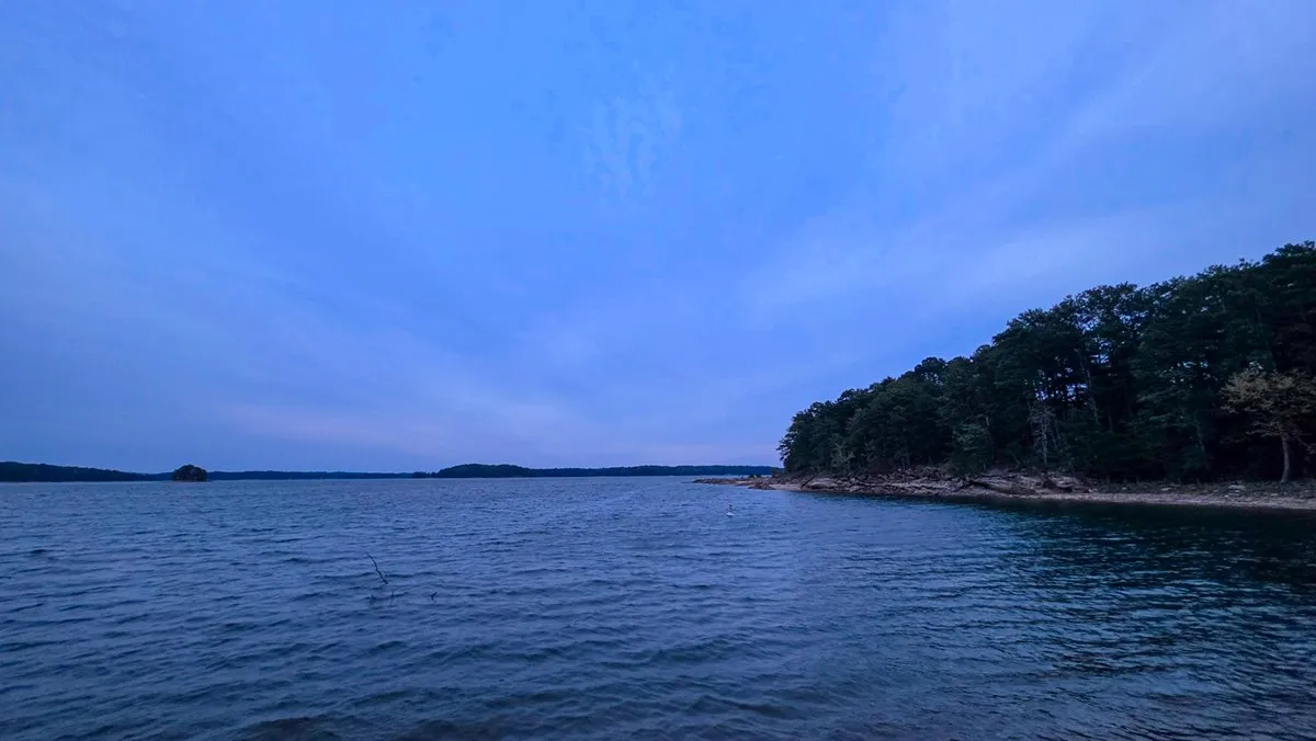 Lake Lanier from Lower Overlook a few minutes before sunrise, a wooded point on the right under a blue-gray sky