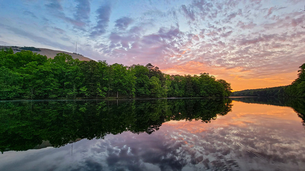 colorful sunrise at stone mountain park with lake